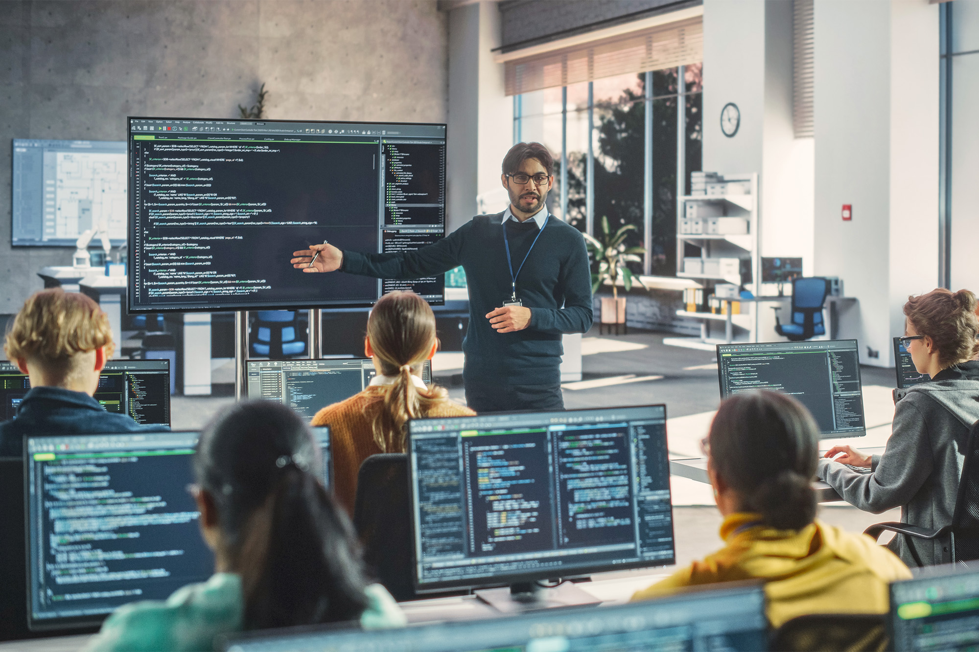 Faculty instructing a computer technology class