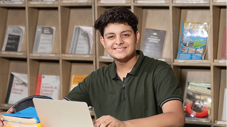 student applying for financial aid on laptop computer