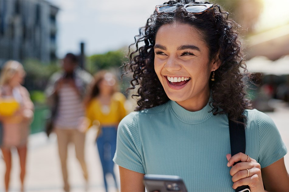 Excited female student with phone