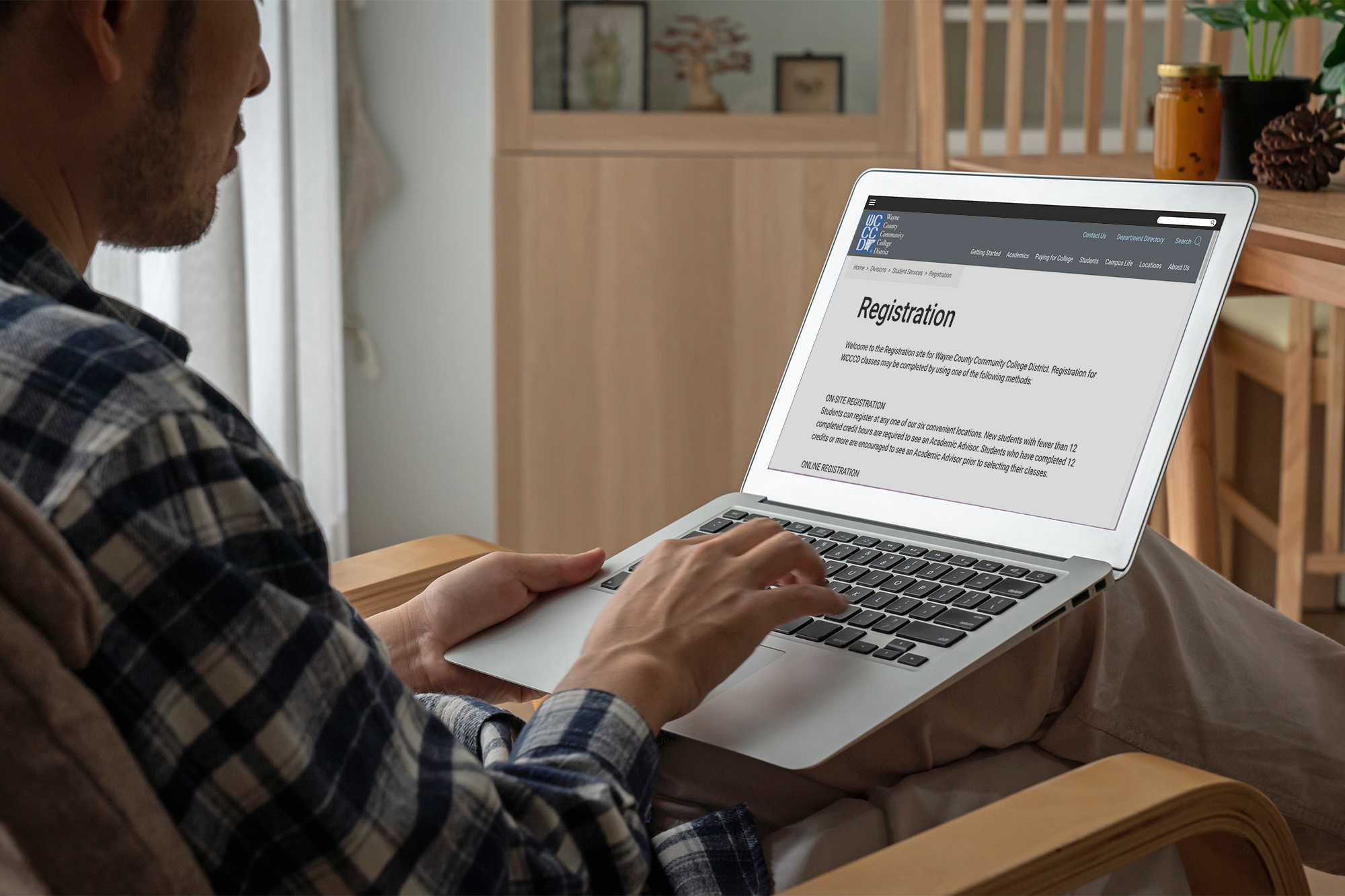 Student registering online with a laptop