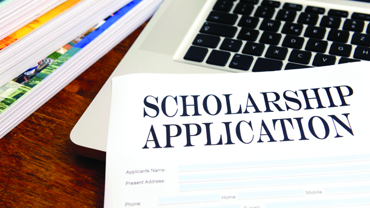 Scholarship paperwork on laptop 